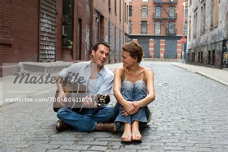 Couple Sitting in Street