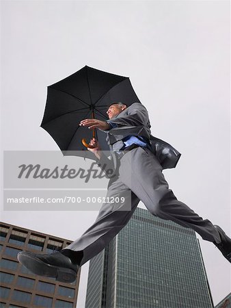 Businessman With Umbrella, Jumping in the Air