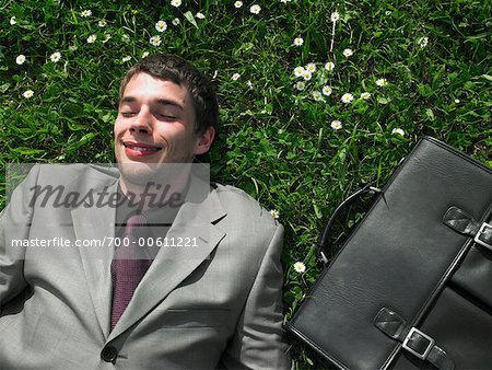 Businessman Lying on Grass