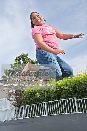 Girl Jumping on Trampoline