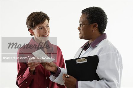 Doctor Giving Prescription to Patient