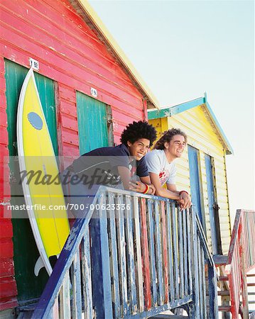 Friends by Beach Hut with Surfboard