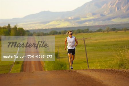 Man Running on Country Road, Boulder, Colorado, USA
