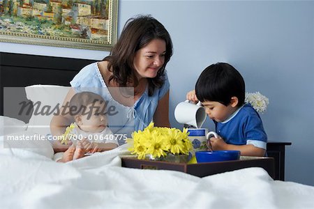 Boy Serving Mother Breakfast in Bed