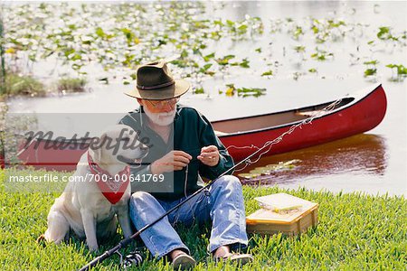 Man with Dog Preparing to Fish