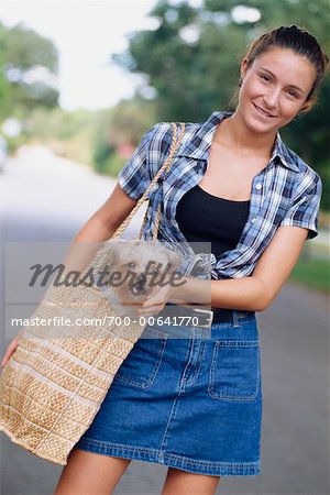 Woman with Dog in Handbag