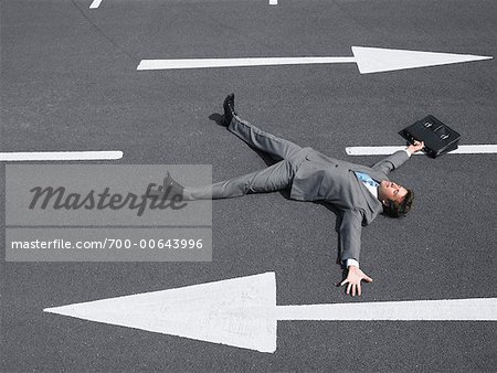 Businessman Lying on Road