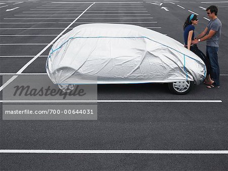 Couple in Parking Lot With Covered Car