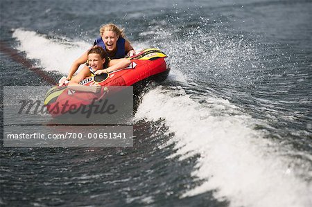 Two Girls Riding in Tube