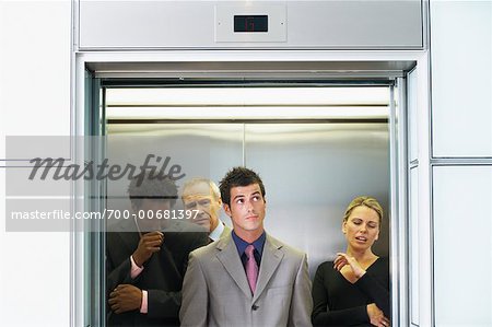Business People on Elevator Smelling Unpleasant Odor