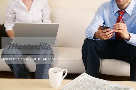 Business People Using Laptop and Electronic Organizer