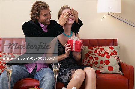 Man Covering Woman's Eyes