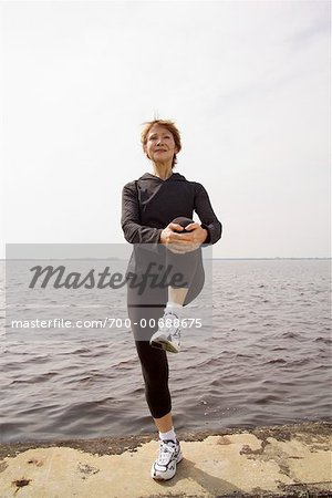 Woman Stretching By The Ocean