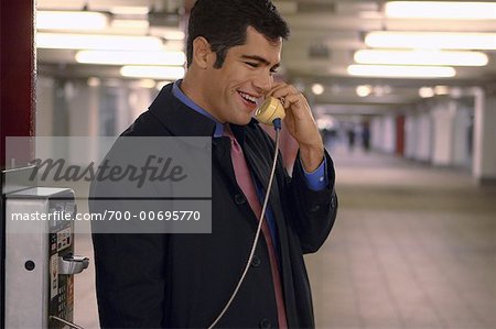 Businessman Using Payphone