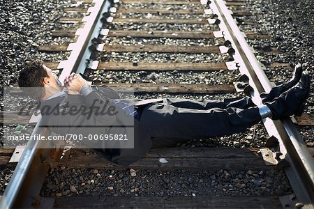 Businessman Tied to Train Tracks