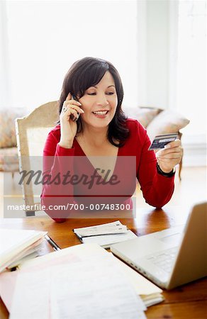 Woman on Cell Phone with Debit Card