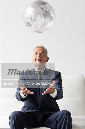 Businessman Throwing Globe