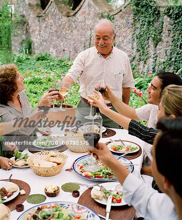 People Making Toast at Dinner Party