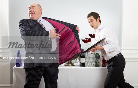 Man Showing Inside of Suit Jacket As Waiter is About to Spill Wine
