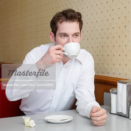 Man Drinking Coffee in Diner