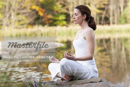 Woman Meditating by Lake