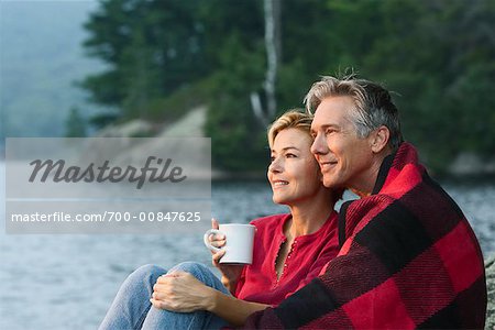 Couple Sitting Beside Lake
