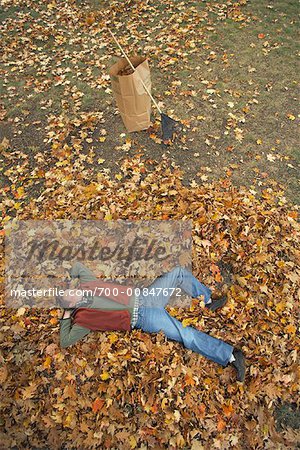 Man Lying on Pile of Leaves