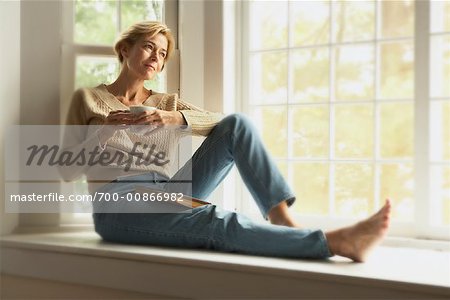 Woman Sitting by Window