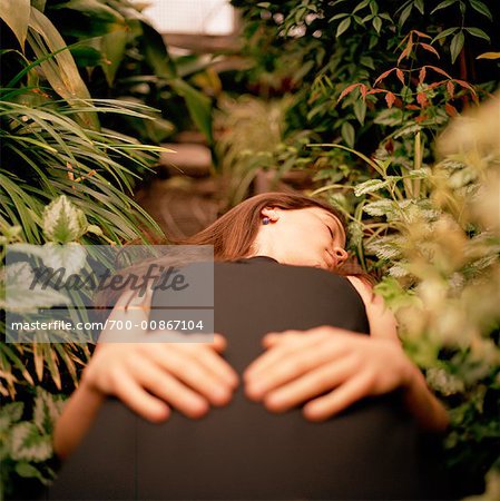 Woman Lying on Path in Garden