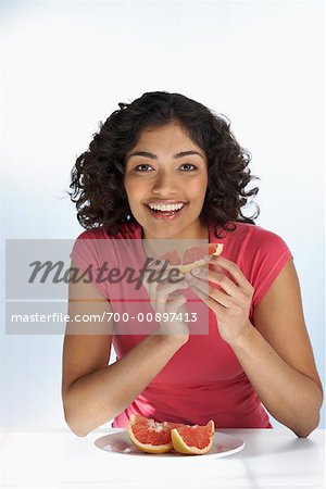Portrait of Woman Eating Grapefruit
