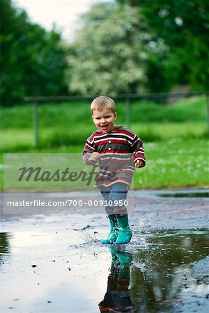 Boy Splashing in Puddle
