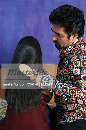 Man Brushing Woman's Hair