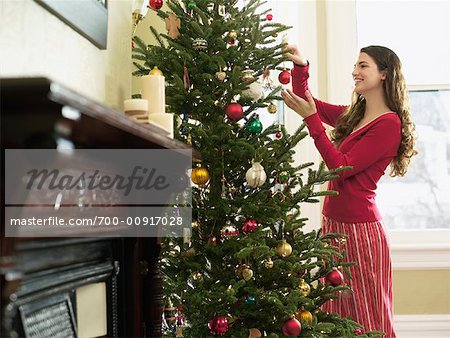 girl decorating christmas tree