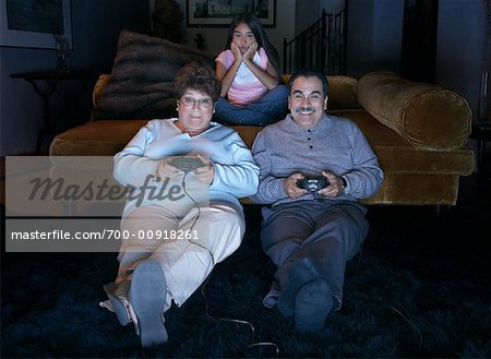 Young Cute Competitive Boyfriend Girlfriend Playing Video Games In Couch  Stock Photo, Picture and Royalty Free Image. Image 34313215.