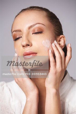 Woman Applying Lotion to Face