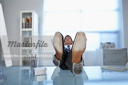 Businessman with Feet Up on Desk