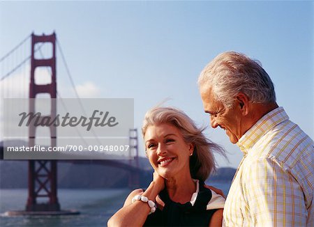 Couple by Golden Gate Bridge, San Francisco, California, USA