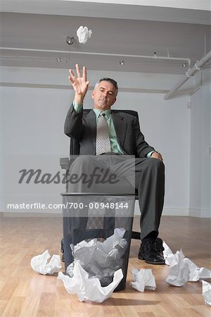 man throwing papers