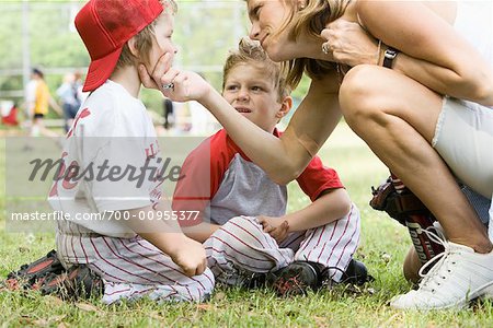 Mother Comforting Son at Baseball Game