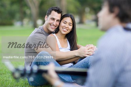 Man Playing Guitar For Couple