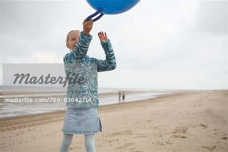 Girl with Space Hopper on Beach