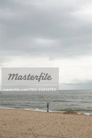 Girl on Beach Looking at Ocean