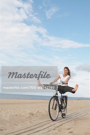 Woman Riding Bicycle on Beach