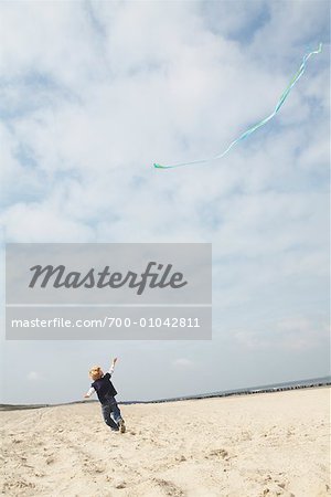 Boy Flying Kite at Beach