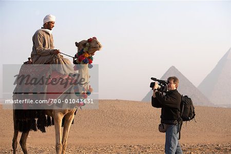 Man Filming Camel Rider, Giza, Egypt Man Filming Camel Rider, Giza, Egypt
