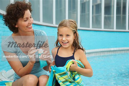 Mother and Daughter Sitting on Pool Side
