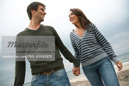 Couple Holding Hands on Beach