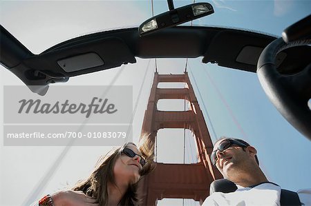 Couple Driving Across Golden Gate Bridge, San Francisco, California