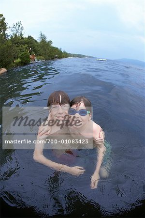 boy swimming in lake