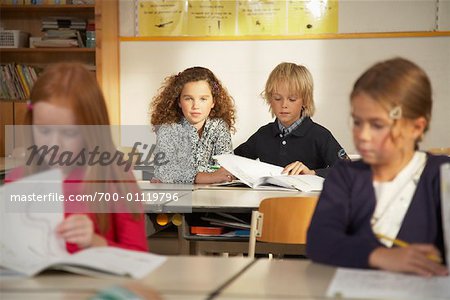 Portrait of Children Sitting at Desks in Classroom